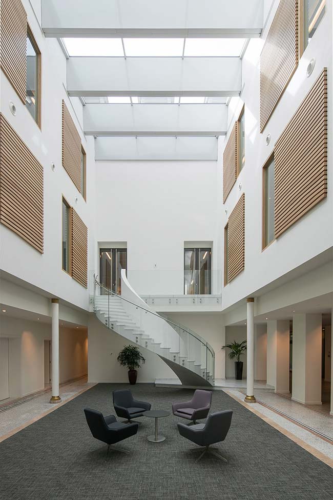 Sculptural staircase brings old and new together in historic Brussels building