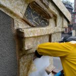 Artist Ian Strange covers historical building in over 600 sq metres of gold wallpaper