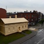 Artist Ian Strange covers historical building in over 600 sq metres of gold wallpaper
