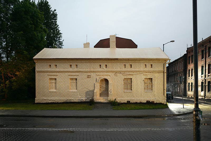 Artist Ian Strange covers historical building in over 600 sq metres of gold wallpaper