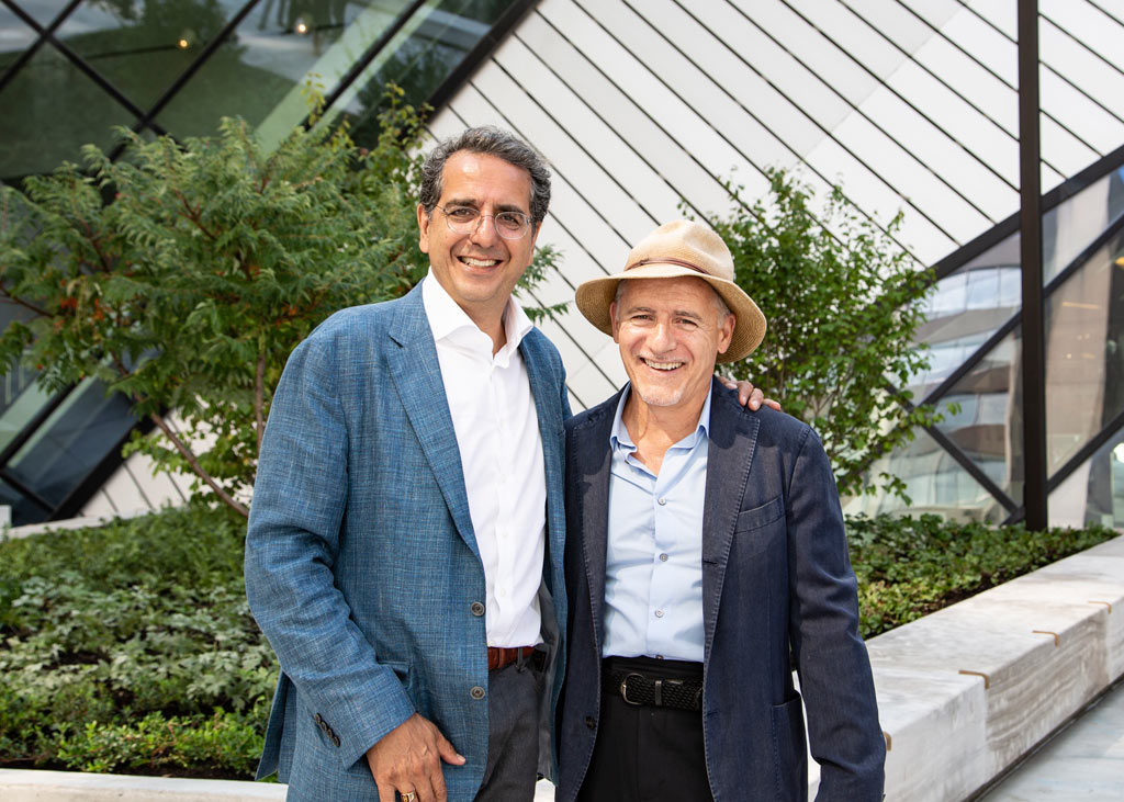 Siamak Hariri and Ron Holbrook standing infront of planters on the Reed Family Plaza