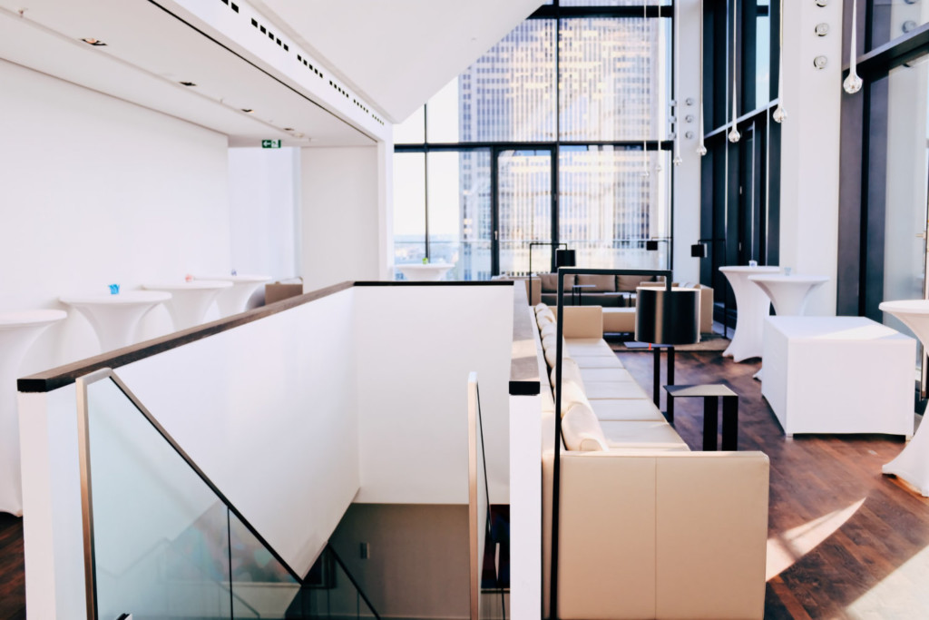 Brown Sofa near stairs in room